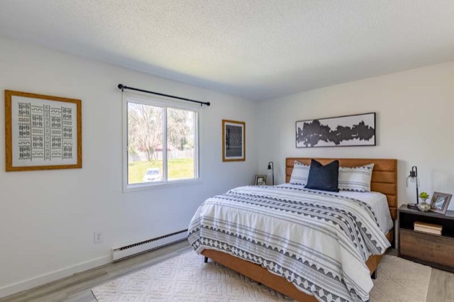 Bedroom with a view of the lawn at The Oaks