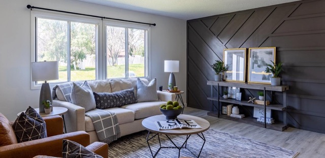 Renovated living room at The Oaks with a paneled accent wall