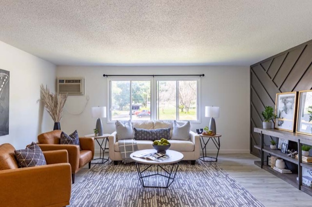 Living room with paneled accent wall at The Oaks