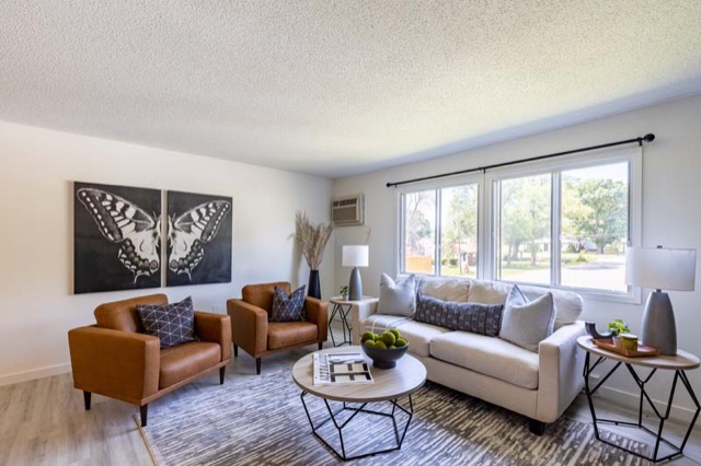 Living room with big windows at The Oaks